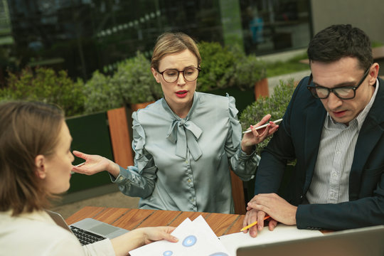 Surprising colleague in glass demanding about stupid mistake