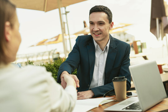 Happy handsome man smiling while making good deal
