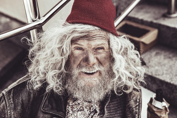 Portrait of unwashed vagrant looking in the camera.