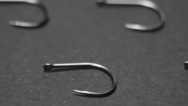 lots of fishing hooks on black background. fishing accessories and accessories