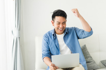 Happy Asian businessman raising his arm up when success, lifestyle concept