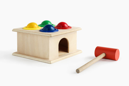 wooden colorful toys hummer and balls on white background perspective view