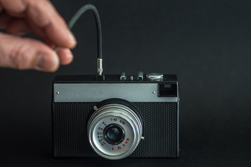 Black Film Camera with control cable. Camera shutter control. Selfies