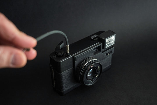 Black Film Camera with control cable. Camera shutter control. Selfies