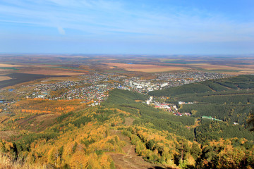 Fototapeta na wymiar Golden autumn in the Altai region in Russia. Beautiful landscape - road in autumn forest