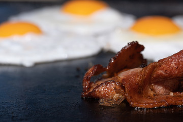 Closeup image of a cooking bacon on a barbecue at a school fundraiser on election day in Australia
