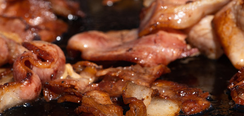 Closeup image of a cooking bacon on a barbecue at a school fundraiser on election day in Australia
