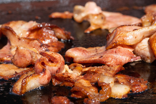 Closeup image of a cooking bacon on a barbecue at a school fundraiser on election day in Australia