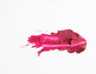 Red shiny lipstick stroke with mother of pearl isolated on white background