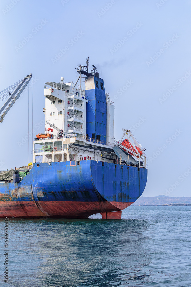 Wall mural a large cargo ship is moving in the sea and moving goods.