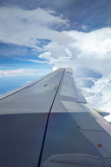 Fototapeta na wymiar Window view of plane on wingside through storm