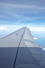 Fototapeta na wymiar Window view of plane on wingside through storm