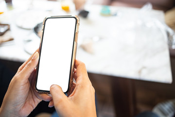 Hands holding mobile phone texting message