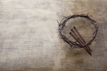 Fototapeta premium Jesus Crown Thorns and nails on Old and Grunge Wood Background. Vintage Retro Style. Free space for text