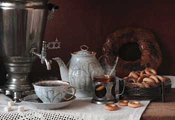 Still life with fragrant tea, a large samovar and cookies
