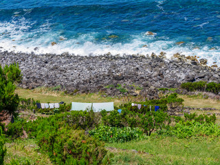 Image of traditional stone house on the coastline of the azores, portugal, europe