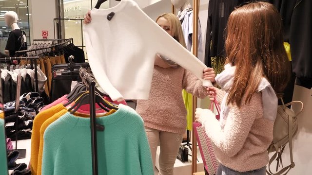 mother and daughter shopping for clothes, mother and daughter buy clothes, white sweater for women