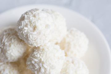 Fototapeta na wymiar Round, white candies in coconut flakes