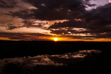 shot through tress of a beautiful sunset in the australian outback with 1 lakes, Nitmiluk National Park, Australia