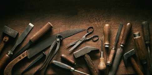 Dark moody arrangement of vintage hand tools