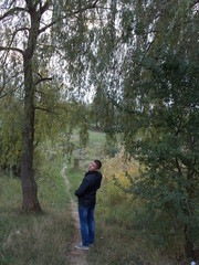 Young man walking in the spring forest
