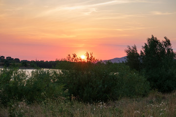 Naklejka na ściany i meble Sunset on a lake in Hohenrode in Germany