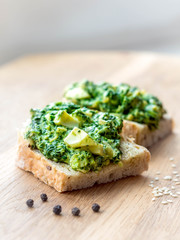 isolated cereal sandwich with chopped spinach, egg and cheese cream closeup, organic healthy diet food