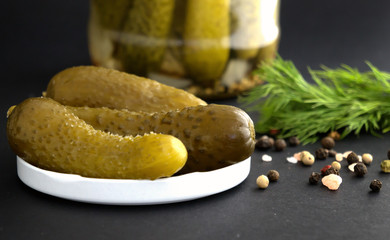 Homemade pikled cucumbers jar with pickles dill and condiments pepper