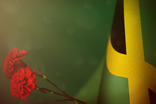 Jamaica Flag For Honour Of Veterans Or Memorial Day With Two Red Carnation Flowers. Glory To Jamaica Heroes Of War Concept On Teal, Sea-green Dark Velvet.