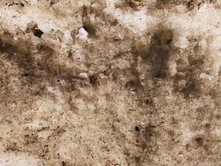 Mountain of dirty snow in the city yard in early spring