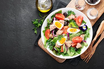 Fotobehang Tuna Fish Salad with Lettuce, Cherry Tomatoes, egg and olives. © Nelea Reazanteva