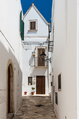 Walking in Locorotondo. Narrow streets and white houses. Dreamlike Puglia, Italy