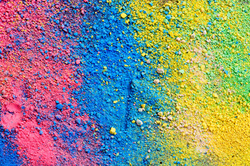 A splatter of pastel natural colored pigment powder on black background.