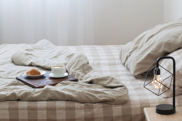 coffee on  tray on the bed in bedroom