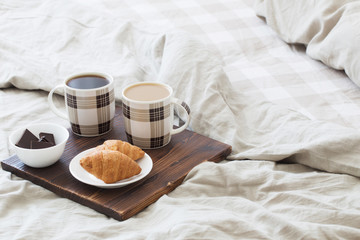two cups of coffee on tray in bedroom