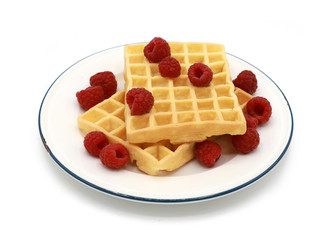 fresh belgian waffles with raspberrys on a plate isolated on white background