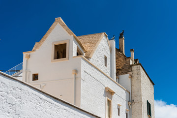Walking in Locorotondo. Narrow streets and white houses. Dreamlike Puglia, Italy