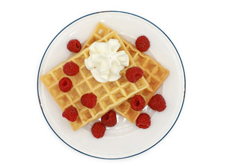 fresh belgian waffles with raspberrys  and whipped cream on a plate isolated on white background