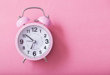 alarm clock on pastel paper background