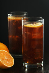 Glasses with cuba libre cocktail or cola with ice or cold tea with lemon