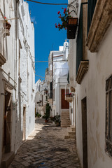 Walking in Locorotondo. Narrow streets and white houses. Dreamlike Puglia, Italy