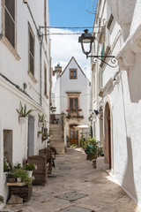 Fototapeta na wymiar Walking in Locorotondo. Narrow streets and white houses. Dreamlike Puglia, Italy