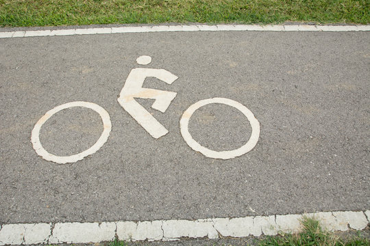 Bicycle lane for riding bicycles. White painted bike on asphalt , Ride ecological green urban transport concepts