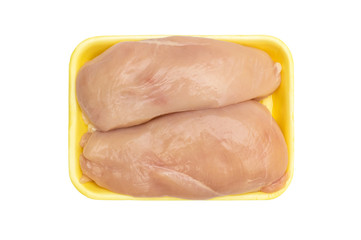 Raw chicken fillet in plastic tray on white. Top view.