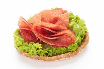 Sandwich with salami sausage on white background.