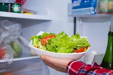 man holding salad boll, diet and health concept