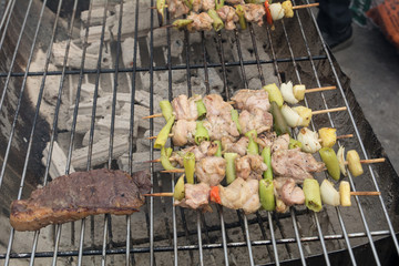 Grilled BBQ on the grill, Barbecue party, Delicious meat on bbq grill (smoke background)