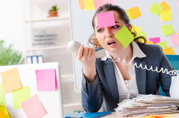 Young female employee in conflicting priorities concept