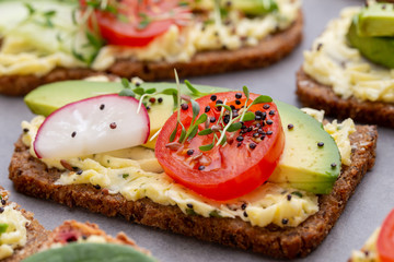 Sandwiches with cream cheese, vegetables and salami.