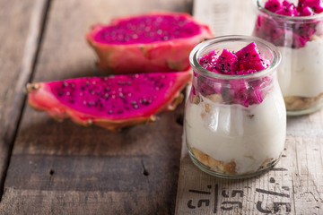 Yogurt with Ripe Dragon fruit, Pitaya or Pitahaya on wooden background, fruit healthy concept